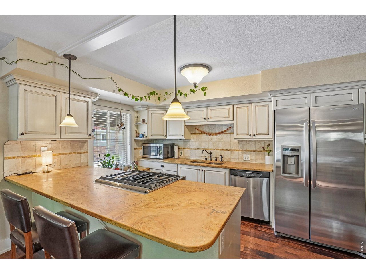 233 North Meldrum Street, Unit 4 Fort Collins, CO 80521 - Photo 1 of 16 a kitchen with stainless steel appliances granite countertop a sink a stove and a refrigerator