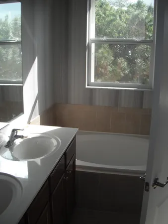 a bathroom with a sink and a window