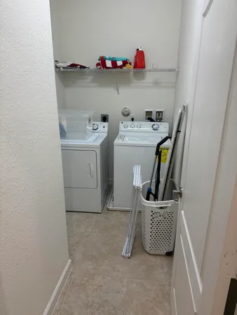 a utility room with sink dryer and washer
