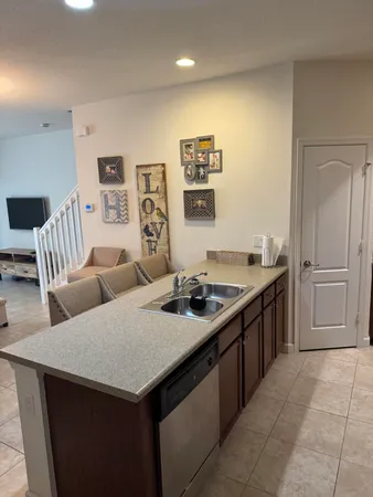 a kitchen with stainless steel appliances granite countertop a sink and a refrigerator