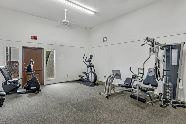 a view of a balcony with floor to ceiling windows and wooden fence