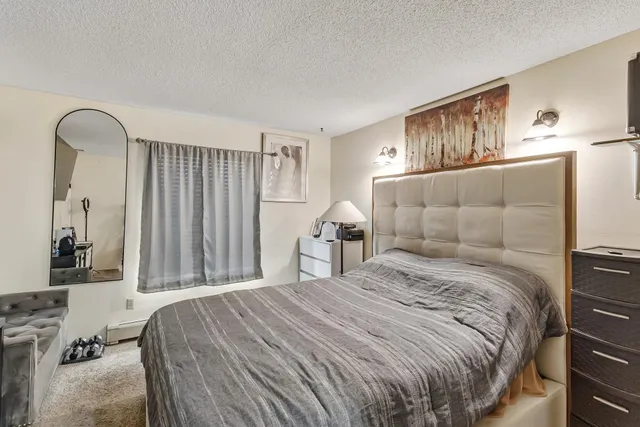 a bedroom with a bed and a mirror