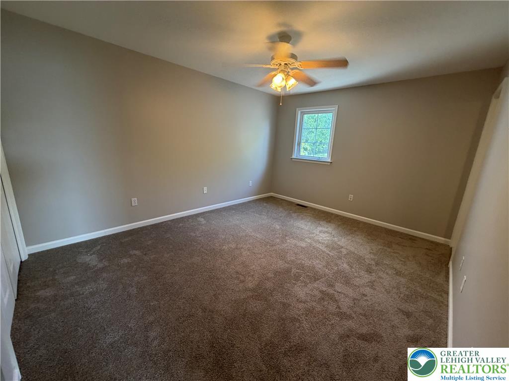 4157 Walter Road Bethlehem, PA 18020 - Photo 22 of 36 Well-lit sleeping quarters with plush carpeting and an overhead light with a ceiling fan for climate control.