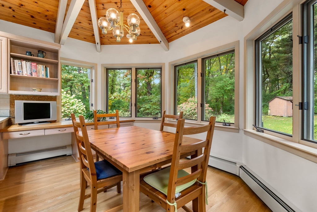 148 Oxbow Road Wayland, MA 01778 - Photo 11 of 32 a dining room with furniture a fireplace and wooden floor