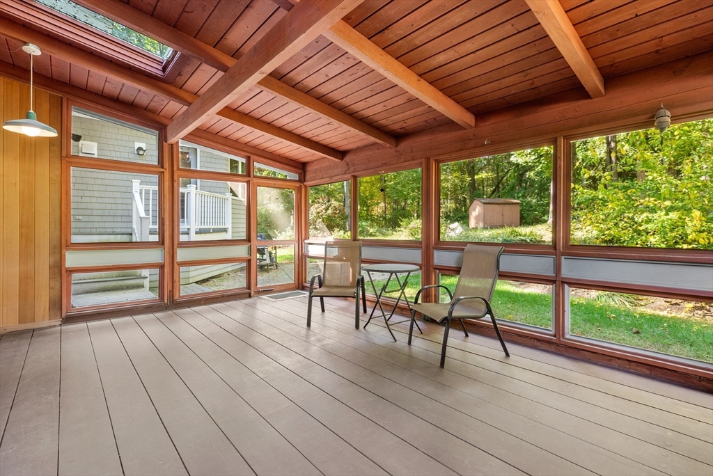 148 Oxbow Road Wayland, MA 01778 - Photo 27 of 32 a view of a patio with table and chairs floor to ceiling window with wooden floor