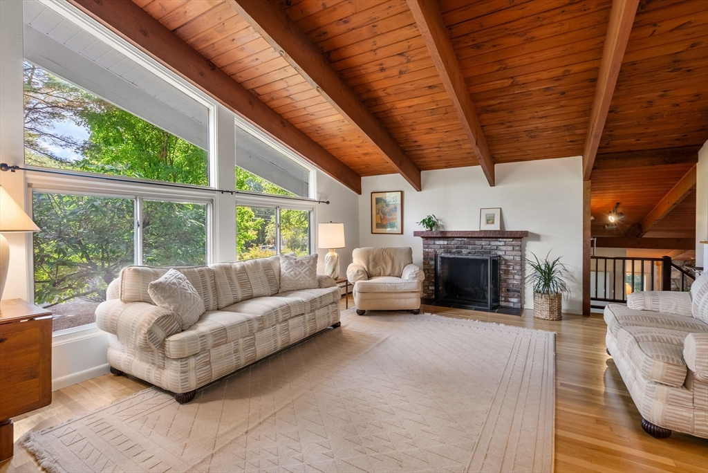 148 Oxbow Road Wayland, MA 01778 - Photo 5 of 32 a living room with furniture a fireplace and a table