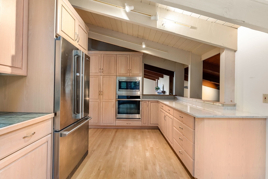 148 Oxbow Road Wayland, MA 01778 - Photo 9 of 32 a kitchen with stainless steel appliances granite countertop a refrigerator and a stove