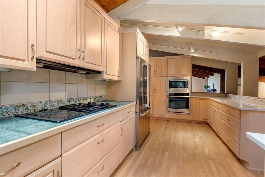 148 Oxbow Road Wayland, MA 01778 - Photo 10 of 32 a kitchen with stainless steel appliances granite countertop a stove and a refrigerator