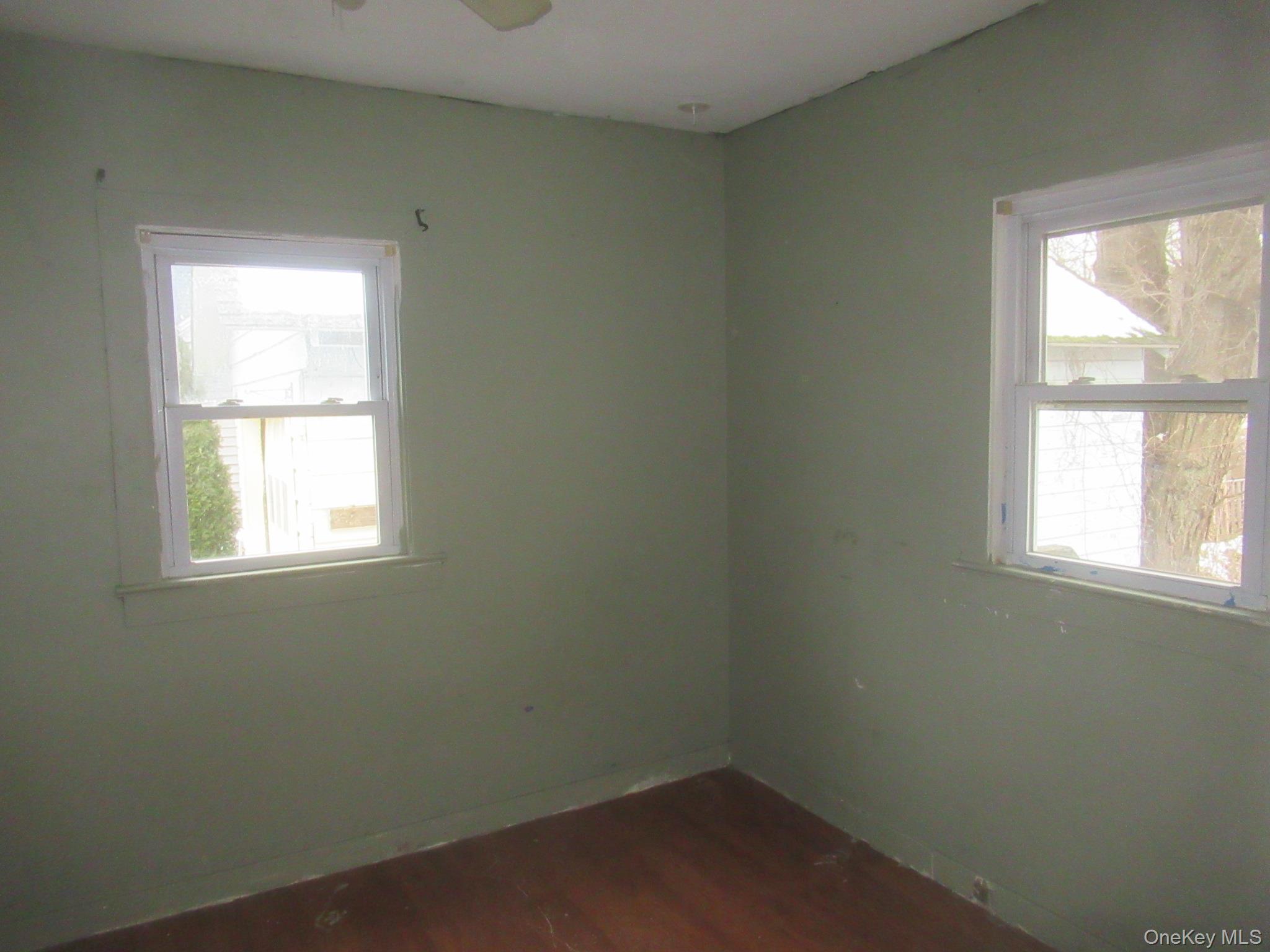 162 Osborne Hill Road Fishkill, NY 12524 - Photo 10 of 11 Unfurnished room with dark wood-style flooring, healthy amount of natural light, and ceiling fan