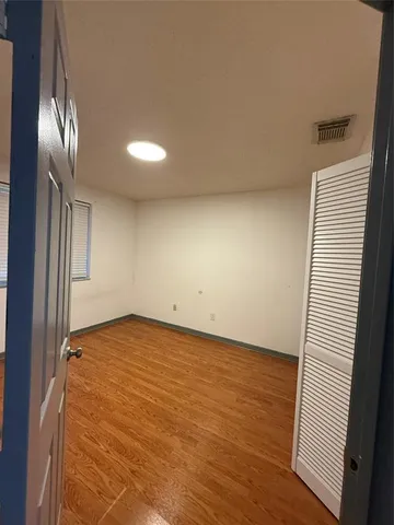 a view of an empty room and wooden floor