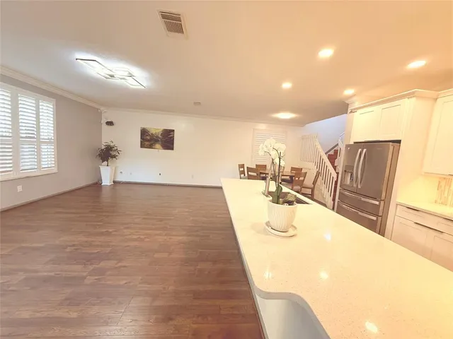 a large white room with wooden floor