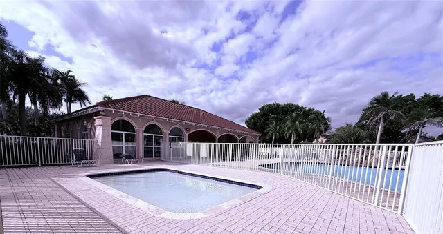 a view of a house with wooden deck and a yard