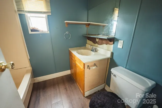 a bathroom with a toilet sink and mirror