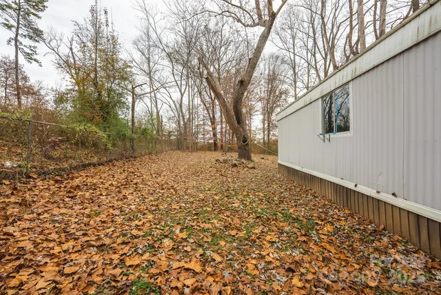 a backyard of a house with large trees
