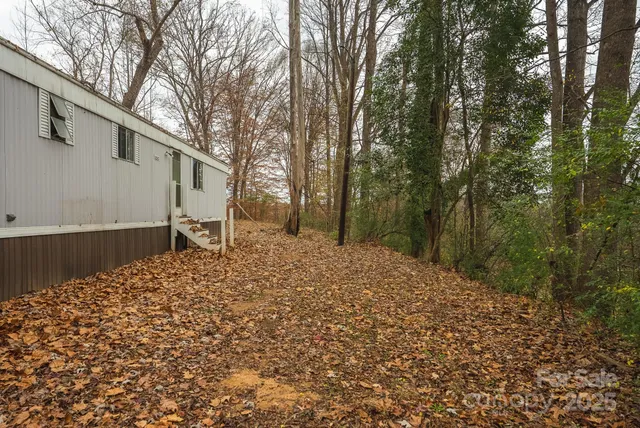 a backyard of a house with large trees