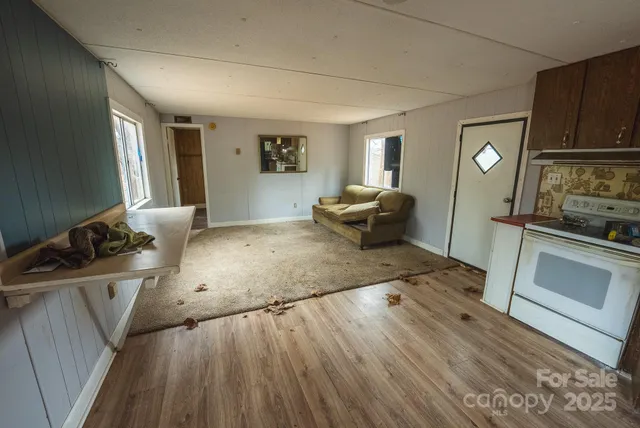 a kitchen with kitchen island granite countertop a sink cabinets and stainless steel appliances