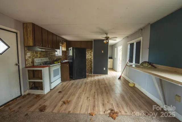 a large kitchen with kitchen island a sink stove and refrigerator