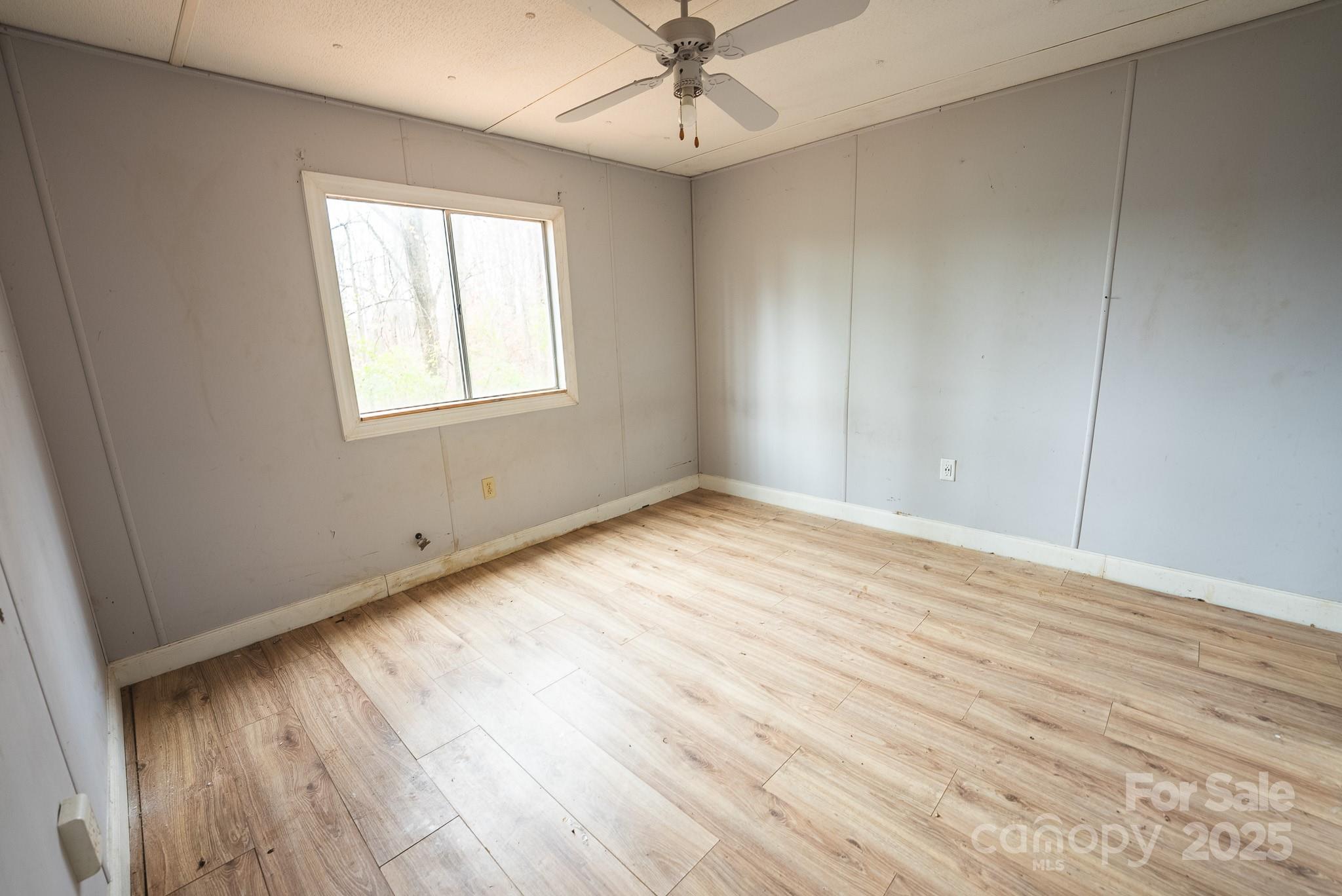 9336 Pinewood Avenue Charlotte, NC 28214 - Photo 25 of 37 wooden floor in an empty room with a window
