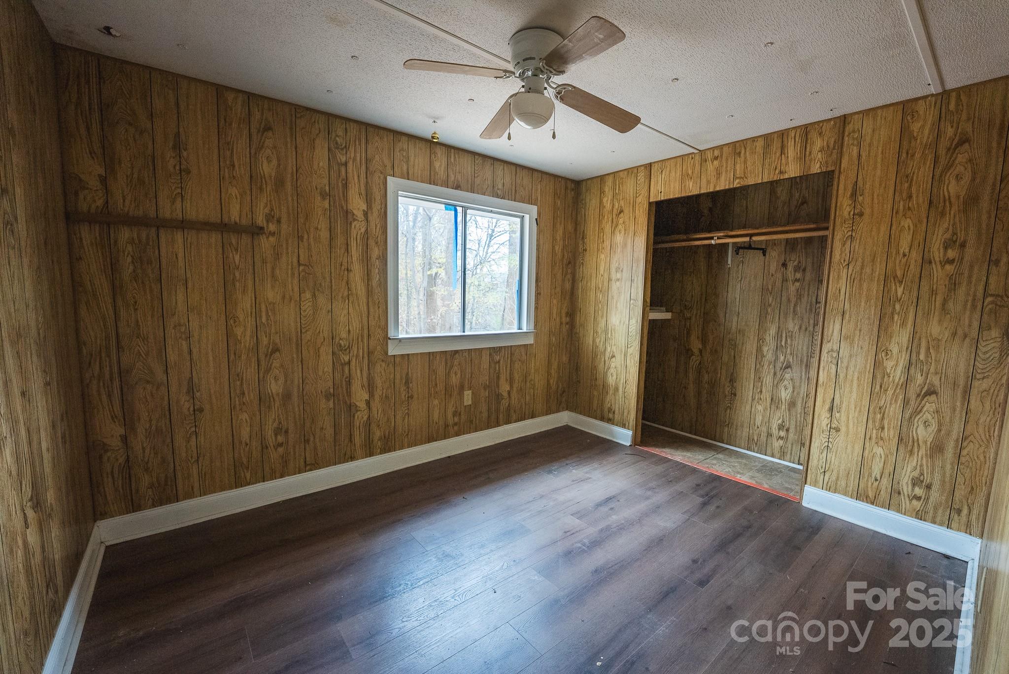9336 Pinewood Avenue Charlotte, NC 28214 - Photo 8 of 37 a view of an empty room with wooden floor and a window