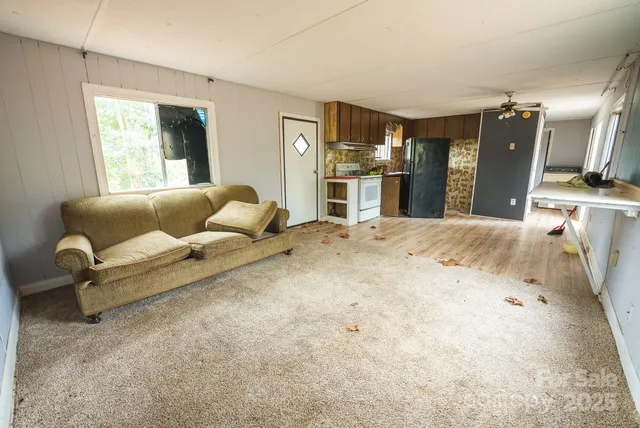 a living room with furniture and kitchen view