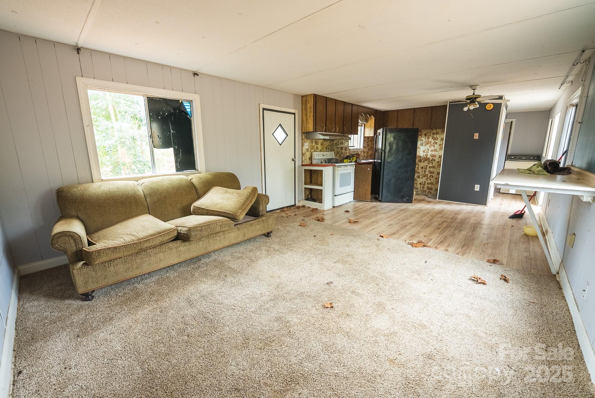9336 Pinewood Avenue Charlotte, NC 28214 - Photo 9 of 37 a living room with furniture and kitchen view