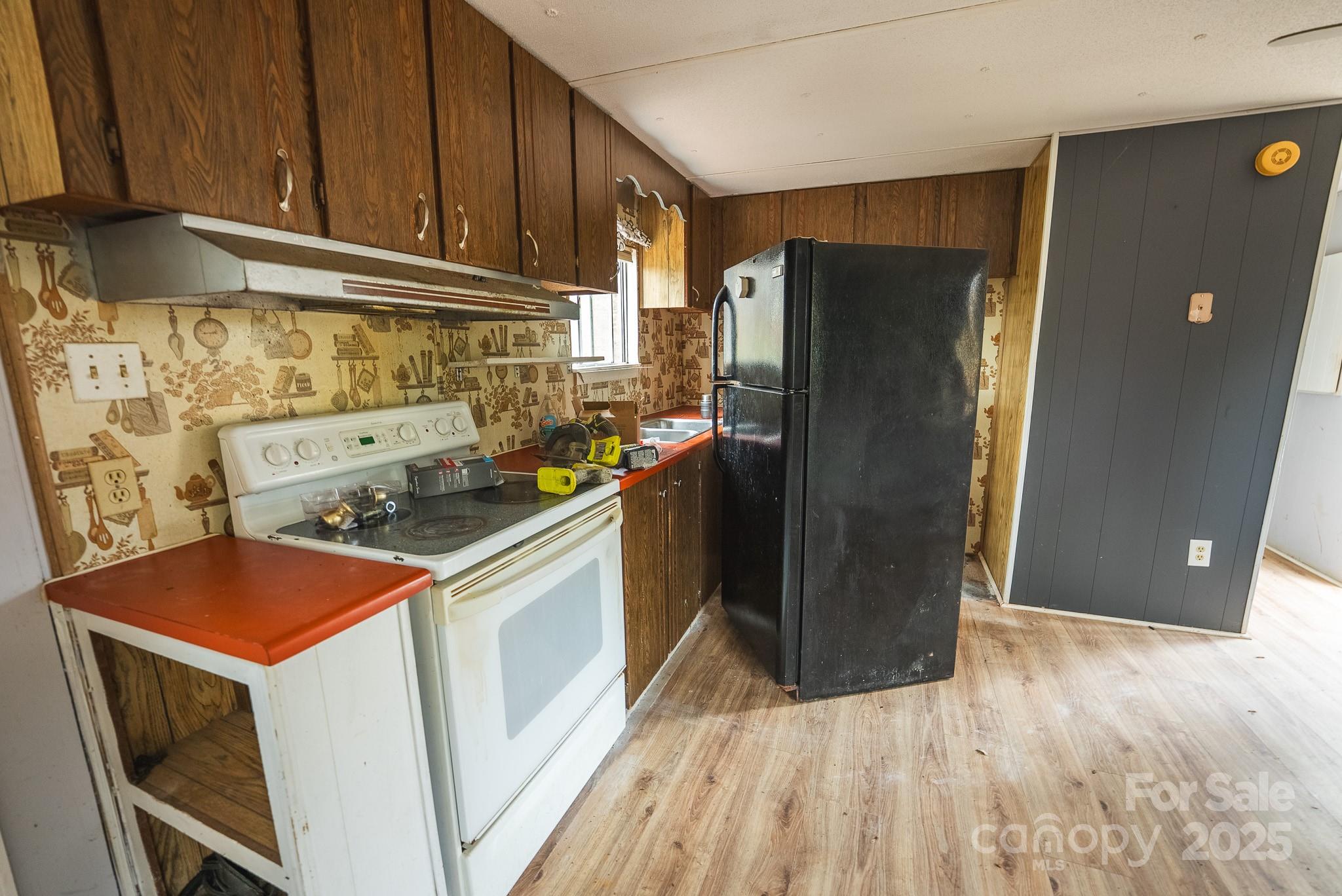 9336 Pinewood Avenue Charlotte, NC 28214 - Photo 10 of 37 a kitchen with a refrigerator sink and cabinets