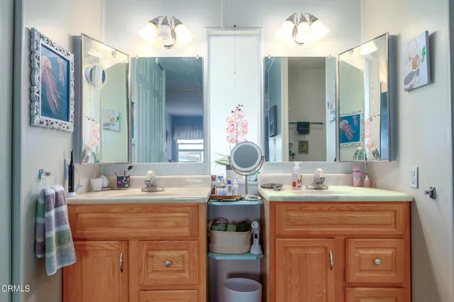 a bathroom with a sink vanity and a mirror