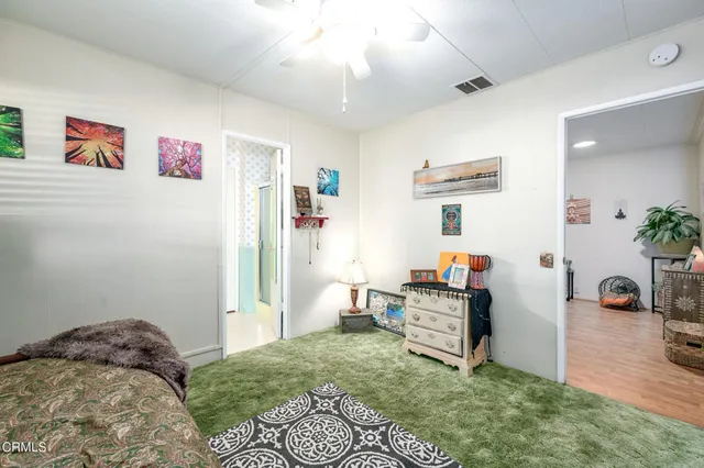 a bedroom with furniture and a book shelf