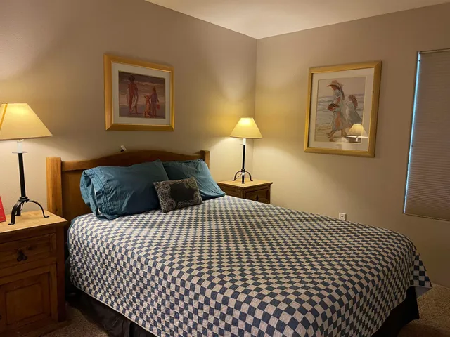 a bedroom with a bed and a lamp