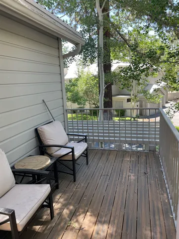a view of deck with table and chairs and wooden floor