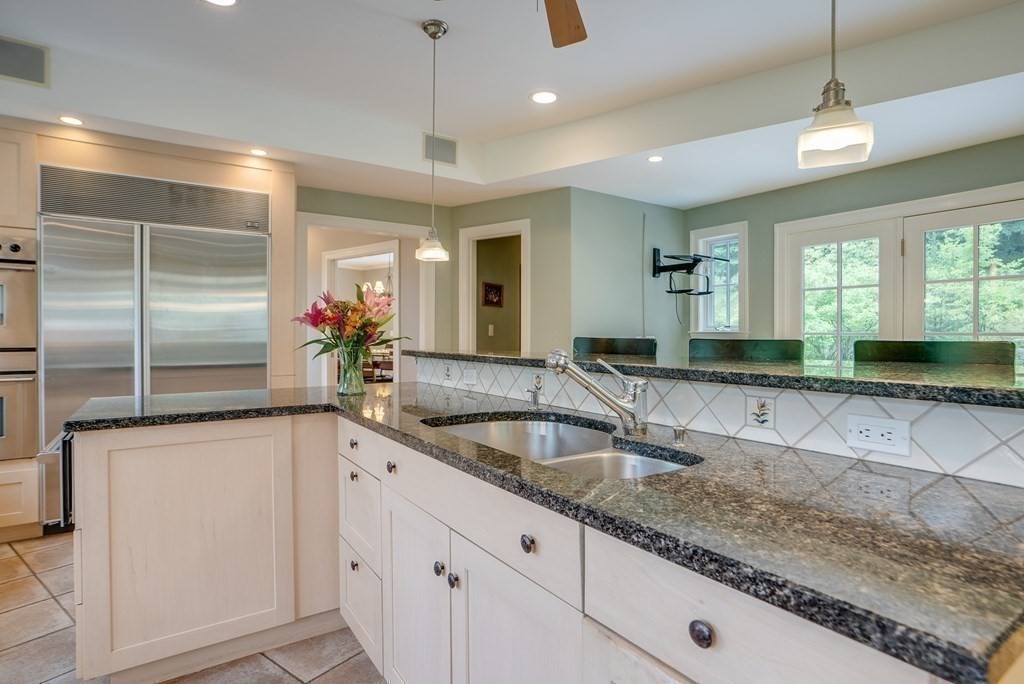 204 Pope Road Acton, MA 01720 - Photo 12 of 40 a kitchen with granite countertop a sink and a refrigerator