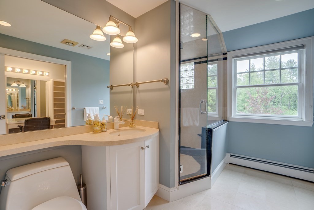 204 Pope Road Acton, MA 01720 - Photo 23 of 40 a bathroom with a double vanity sink toilet and a mirror