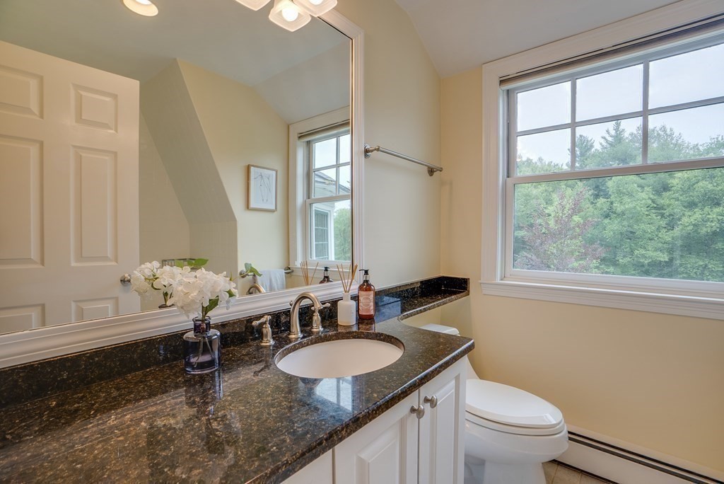 204 Pope Road Acton, MA 01720 - Photo 30 of 40 a bathroom with a granite countertop sink a toilet and a window