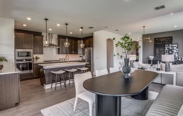 a kitchen with a table and chairs