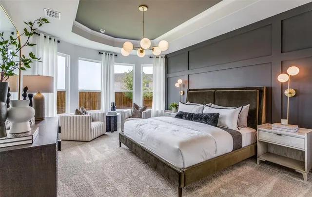a bedroom with bed and a chandelier