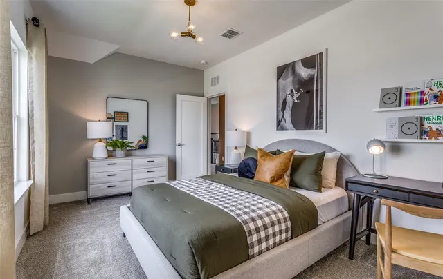a bedroom with a large bed and ceiling fan