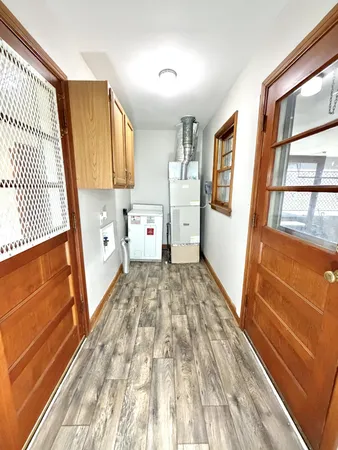 a view of a bedroom with wooden floor and furniture