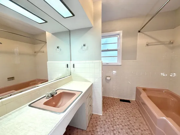 a bathroom with a tub sink and toilet