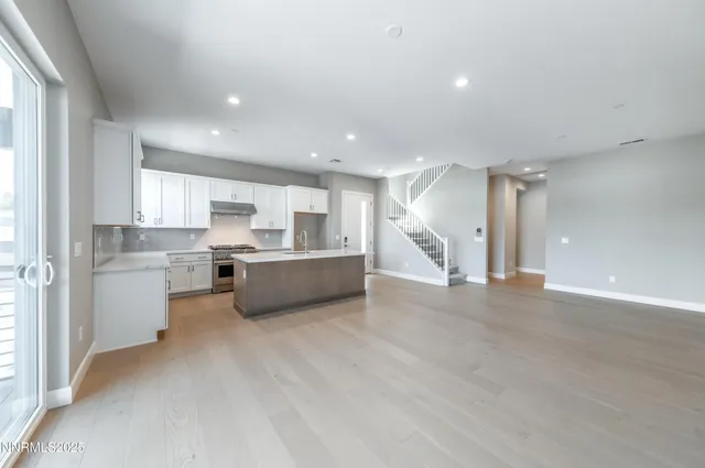 a view of kitchen with kitchen island and stainless steel appliances