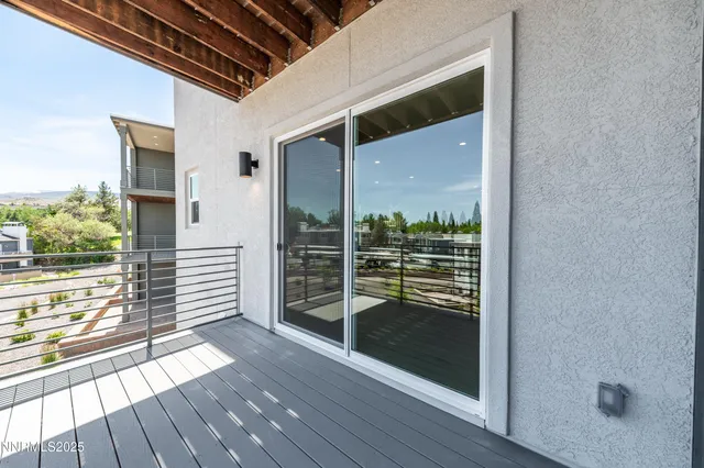 a view of a balcony with wooden floor