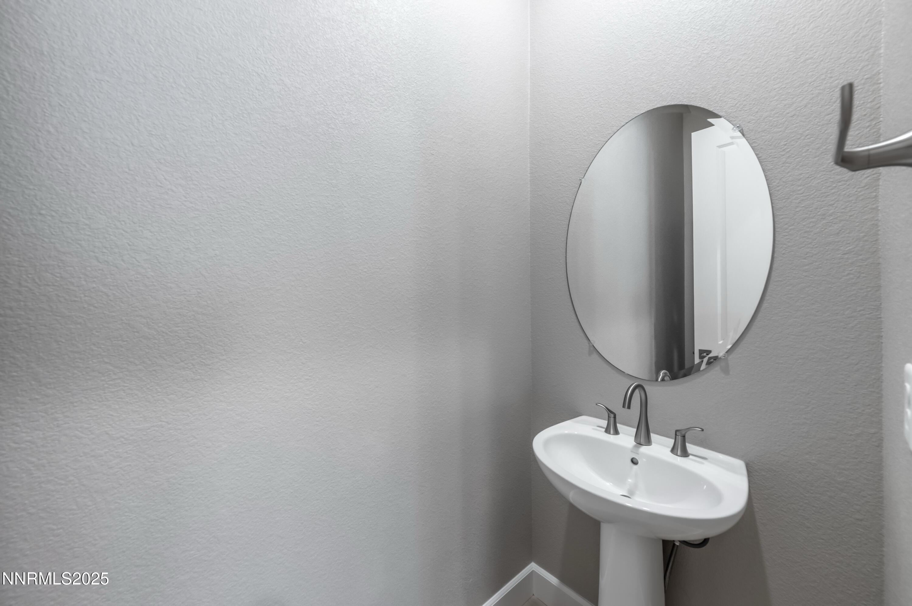1513 Golf Club Drive Reno, NV 89519 - Photo 13 of 34 a bathroom with a sink and a mirror