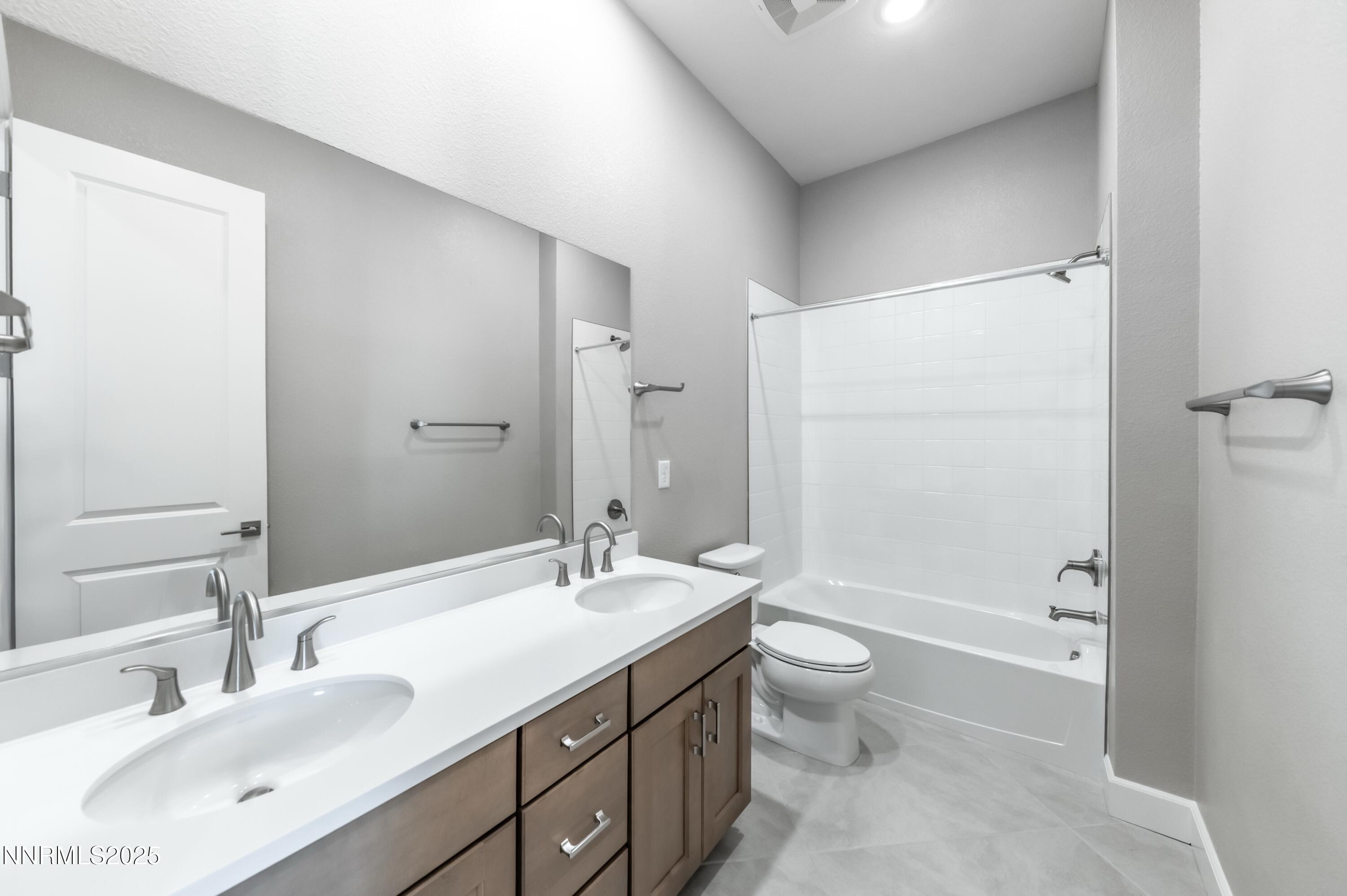 1513 Golf Club Drive Reno, NV 89519 - Photo 19 of 34 a bathroom with a double vanity sink toilet and shower