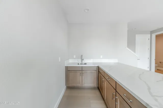 a view of a kitchen with a sink and a dishwasher