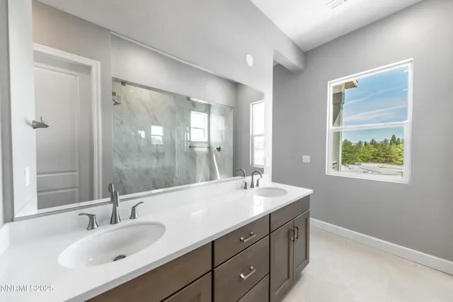 a bathroom with a double vanity sink mirror and double