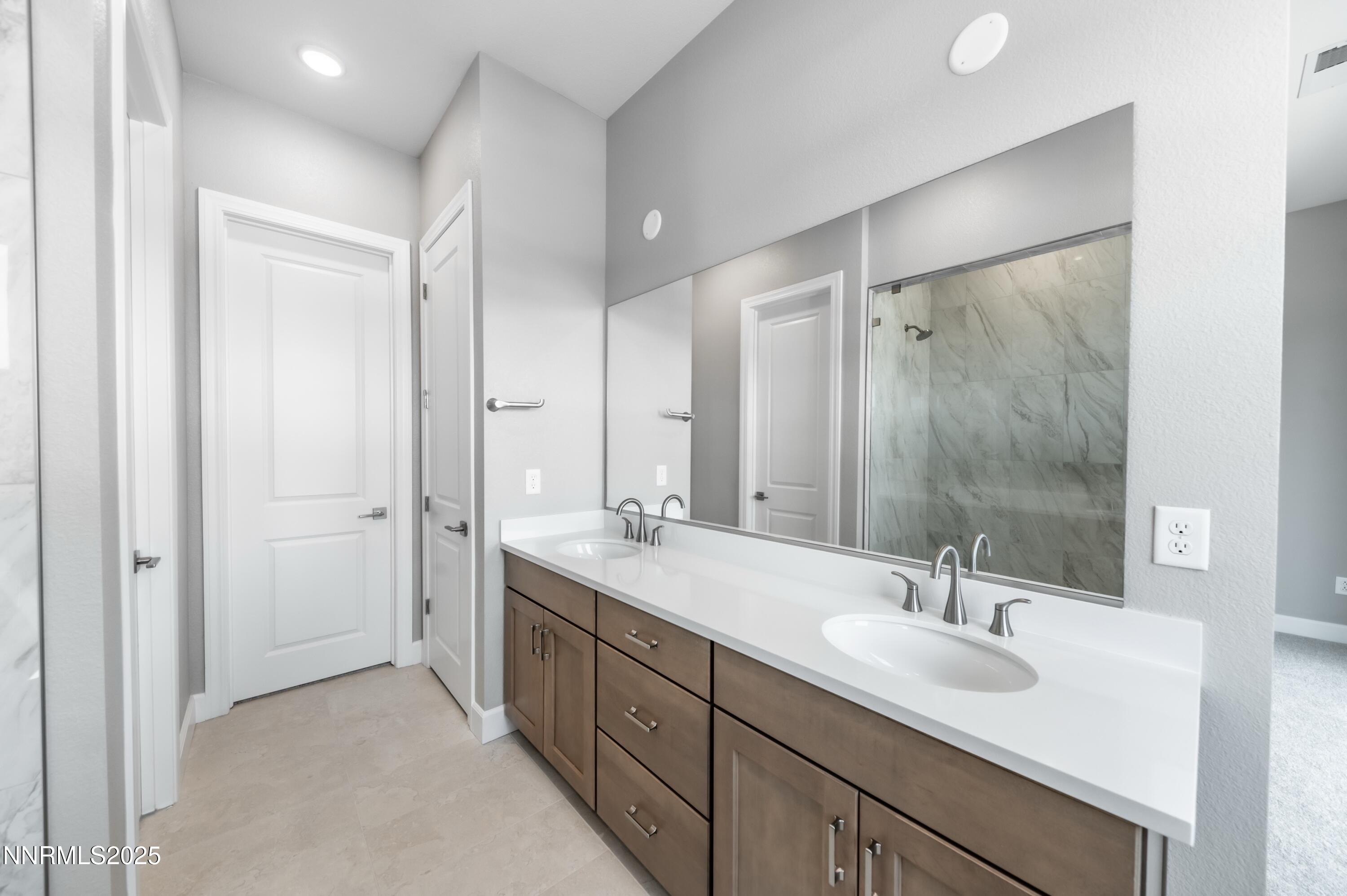1513 Golf Club Drive Reno, NV 89519 - Photo 24 of 34 a bathroom with a double vanity sink mirror and double