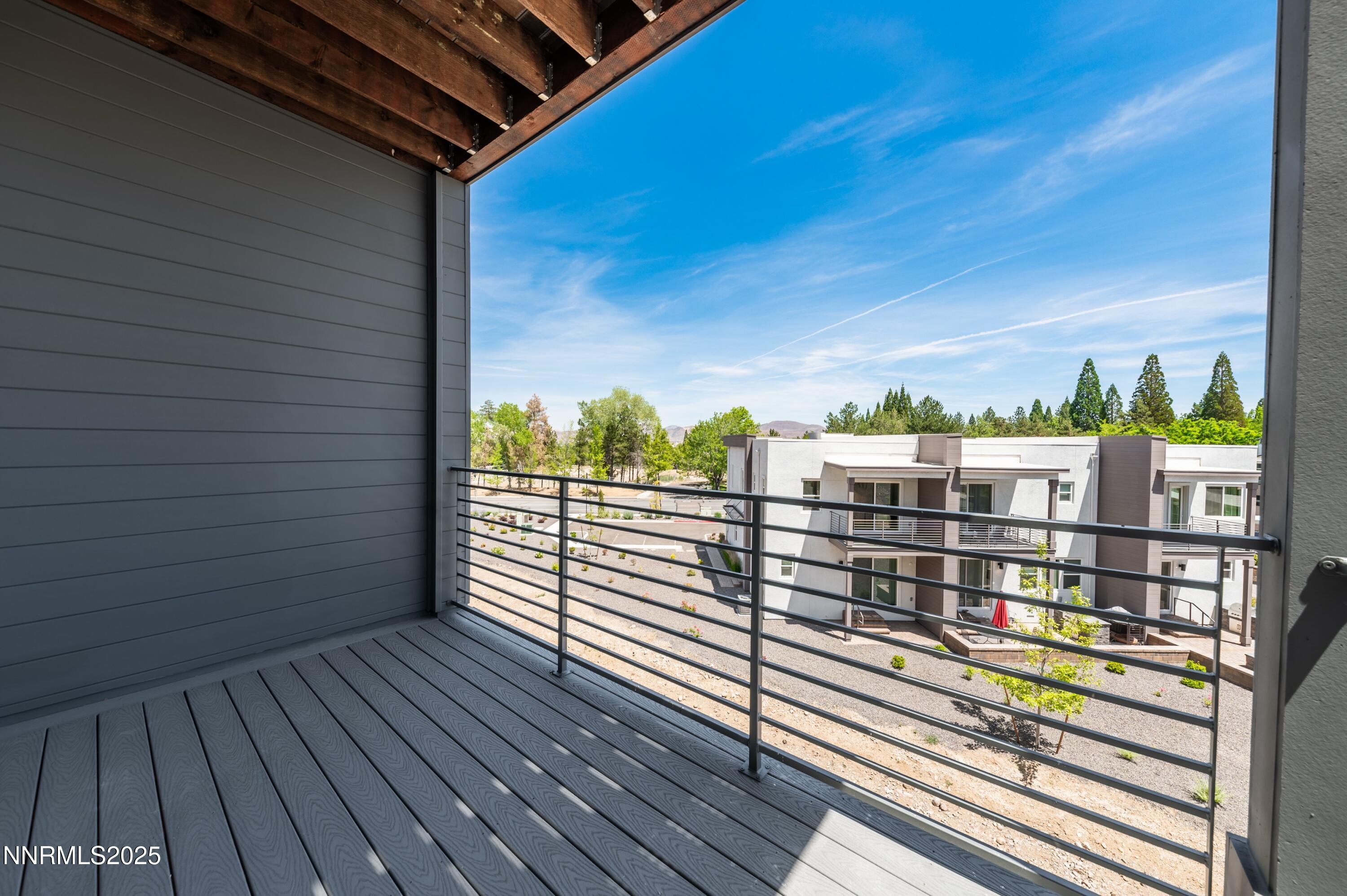 1513 Golf Club Drive Reno, NV 89519 - Photo 33 of 34 a view of a balcony with floor to ceiling windows with wooden floor