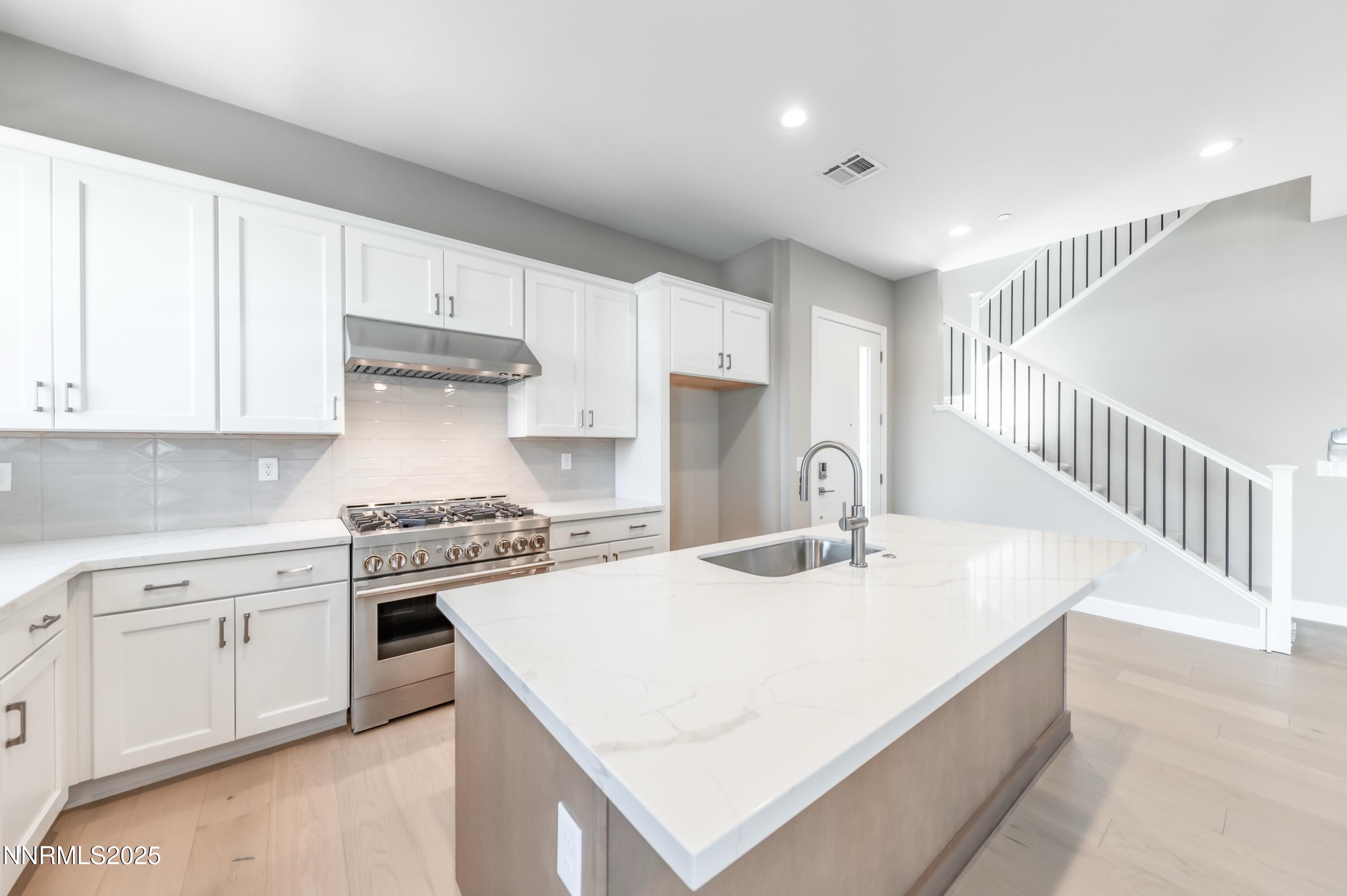 1513 Golf Club Drive Reno, NV 89519 - Photo 4 of 34 a kitchen with a white cabinets stove and sink