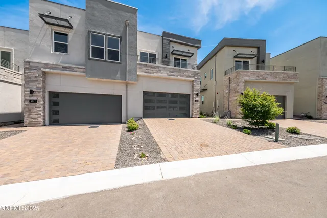 a front view of a house with a yard and a garage