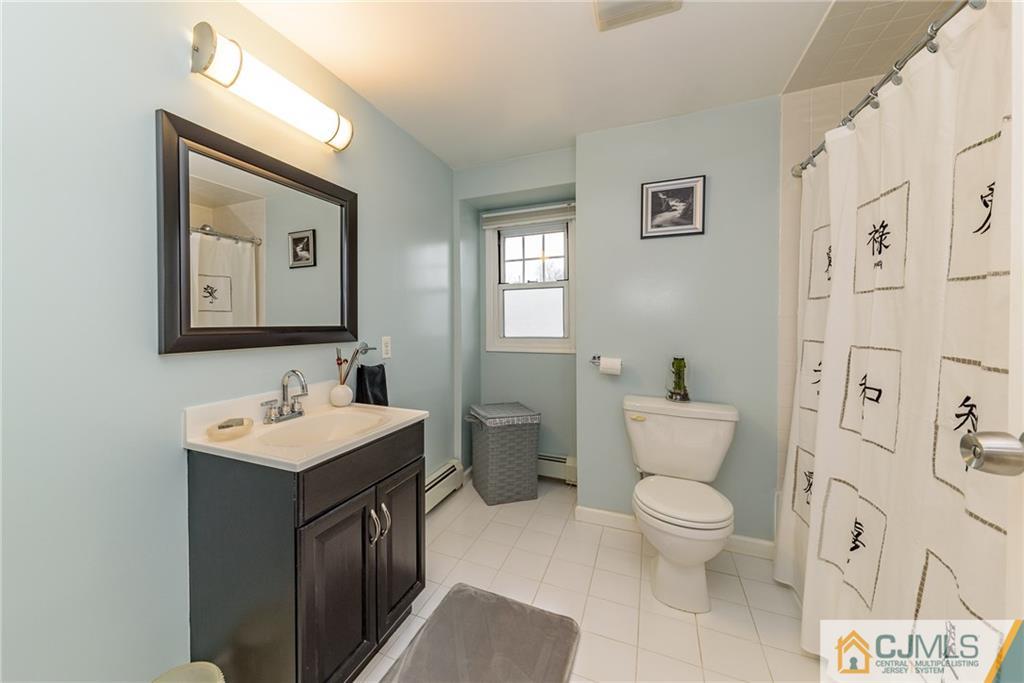30 South Hill Road Colonia, NJ 07067 - Photo 22 of 25 a bathroom with a toilet sink and mirror