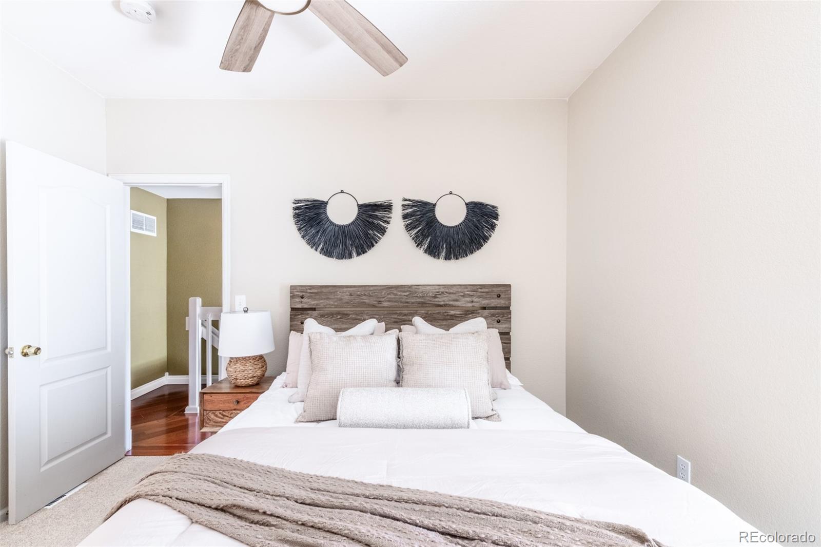 1650 South Deframe Street, Unit B5 Lakewood, CO 80228 - Photo 13 of 40 a bedroom with a bed and a chandelier